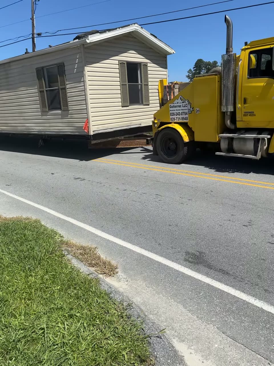 A single-wide coming around a corner behind our truck
